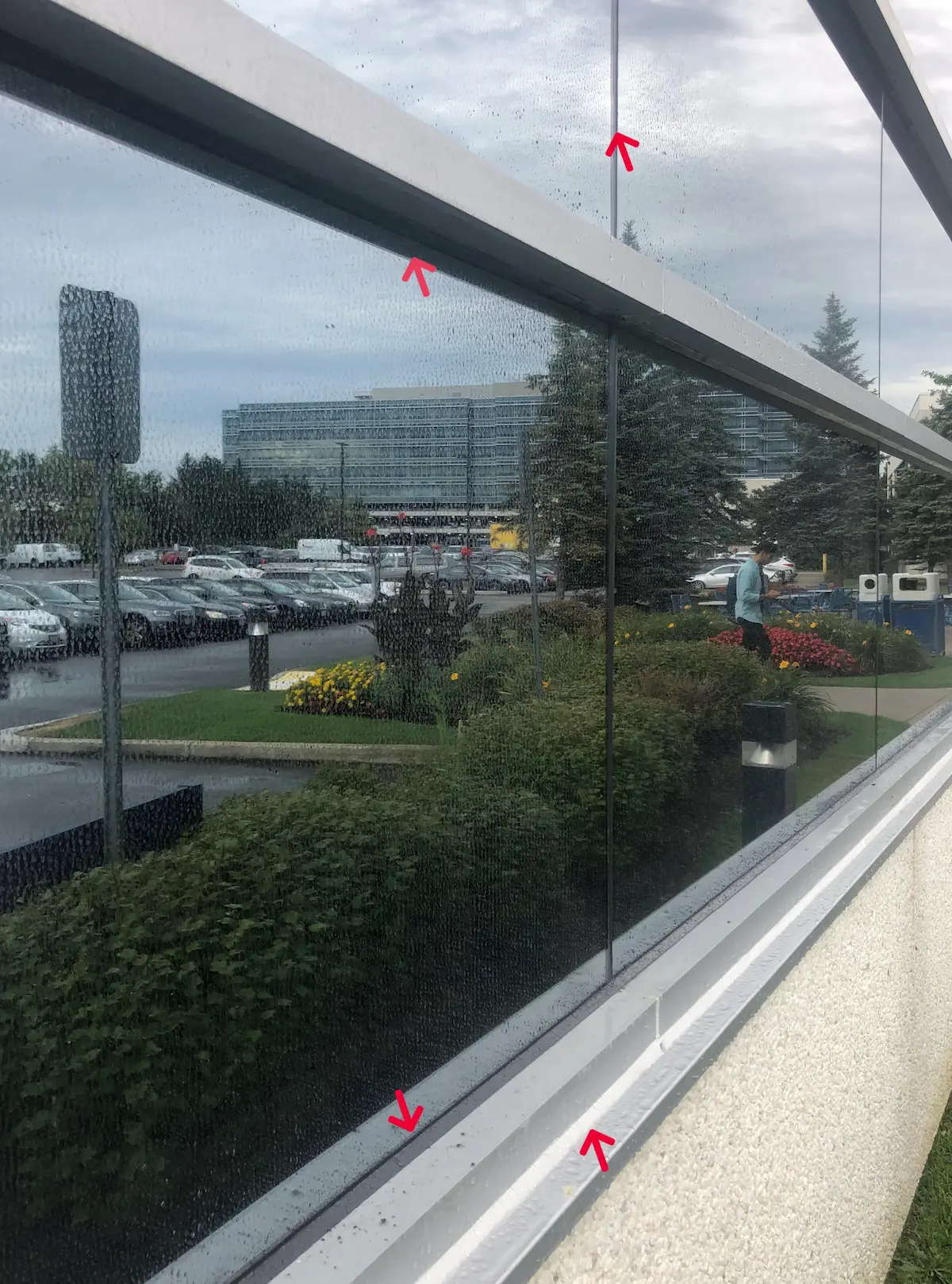 Worker caulking a window