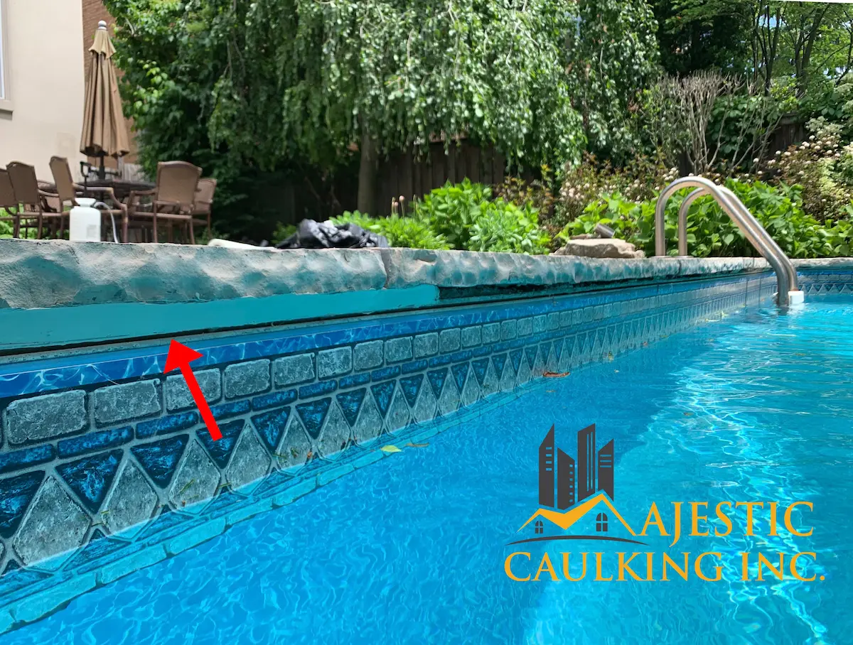 Worker caulking a window